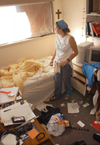 After a day of helping others with tornado-related repairs, sophomore Leah Taylor from Siloam Springs, AR stops for a moment in her own room to begin the cleaning process. - Photo by Jim Veneman