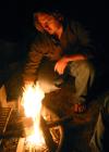 Ariel Gee builds a fire to heat up a cold night during the art retreat. - Photo by Stephanie Schroeder
