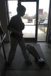 Freshman Brittney Cole, undecided major, vacuums the entrance rug at Youth Town for part of her Day of Remembrance project.      - Photo by Kyle Kurlick