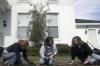 Lily Zopfi, Carolyn Jennings and Carly Ford weed out a walkway at The Care Center during Day of Remembrance. - Photo by Kyle Kurlick
