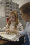 Junior Mary Ellen Vaughn, learning foundations major, reads to a child at Jackson Christian School on the Day of Remembrance. - Photo by Holly Gushee