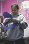 Freshman Lyda Kim punches out paper cut-outs of animals in order to decorate one of the classrooms of Iglesia Bautista Hispania Church located at Poplar Heights Baptist Church during Day of Remembrance. - Photo by Stephanie Schroeder
