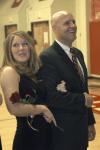 Junior Carolyn Negley, learning foundations major, is escorted off the court by her father during the Homecoming queen ceremony.  - Photo by Matthew Diggs