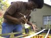 The window wedges at the Young Life house needed painting and who better to do it than SAC President Jande Jackson on Day of Remembrance.  - Photo by Beth Spain