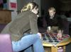 Senior John Kay, history major, plays a game of checkers with Senior Andrea Sarine, nursing major, during the senior class' Ode to Bubba's Bagels party in the student lounge.  - Photo by Matthew Diggs