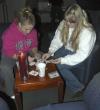 Senior Amanda King, social work major, plays a game of cards with Senior Ashley Donahue during the senior class' Ode to Bubba's Bagels party in the student lounge. - Photo by Matthew Diggs