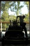 Before a riding mower can be driven out to do it's job, the oil must be checked, gears must be greased and the tank filled. Matt Brasfield goes through this checklist every day before mowing.   - Photo by Matthew Diggs