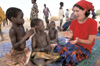 While sharing laughter and smiles with a couple of village children, sophomore Erin Joseph saw firsthand the hunger and poverty of the Marense. From the <i>Unionite</i> feature: <i>They Came To Join In</i> - Photo by Warren Johnson