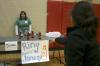 Anna Townsend watches as April Boyd attempts to land a ring around a Jones Soda Co. bottle in order to win a prize at the Ring around the Jonesy game at the carnival during Frost Fest put on by SAC. - Photo by Stephanie Schroeder