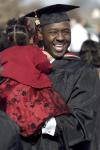 Marlon Heidelberg, MBA graduate, celebrates with his daughter Mackenzie while greeting friends and family after fall graduation. - Photo by Kyle Kurlick
