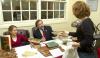 The Father-daughter team of Hal Poe, the Charles Colson Professor of Faith and Culture, and Junior Rebecca Whitten Poe, English major, sign copies of the book they edited <em>C.S. Lewis Remembered,</em> for Senior Melody Pickerill, Christian studies major. - Photo by Matthew Diggs