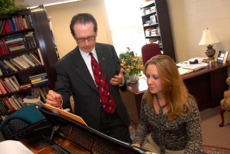 Ron Boud, professor of music, works with Kate Rawls during a keyboarding lesson.
