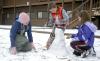 02/2/07 - Senior Katie Watson, ESL major, helps Isaac and Anna Elliott, children of McAfee resident director Kelly Elliott, to build a snowman.