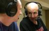 Steve Beverly converses with co-host and senior David Roach during the 2007 NAIA Tournament games. Beverly celebrated his 200th game as host and announcer during the tournament. - Photo by Stephanie Schroeder