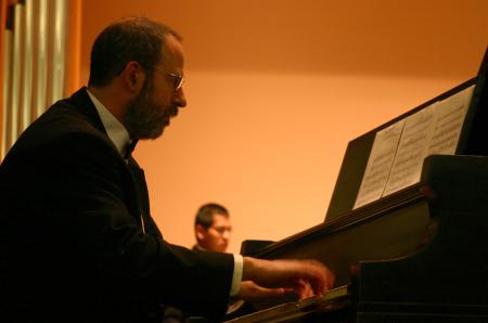Terry McRoberts accompanies the Union Symphonic Band on the piano during the end of the semester concert.