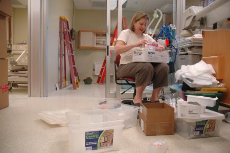 Beckie Kossick unpacks material for the simulation center in the Center for Excellence in Health Care Practice located in White Hall.