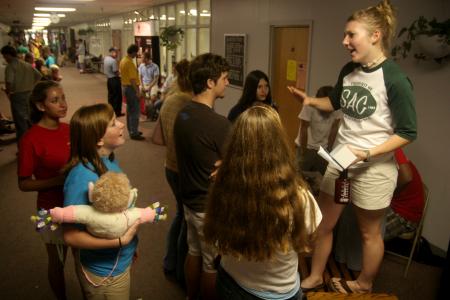 Bekah Bothwell talks to Bethany Hobbs as new students gather around at the student life fair during New Student Orientation.