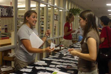 Brittany Howerton, senior public relations major and Focus leader, gives Rebecca Montgomery, an engineering major from Memphis, Tenn., and other new students their name tags they use for orientation before classes begin.