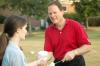 Gary Carter, senior vice president for business and financial services, serves ice cream to new students at an ice cream social held at the home of President Dockery.  - Photo by Matthew Diggs