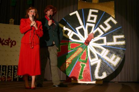 Kinsey Bolinger and Kieler Henry stand in front of the big wheel at SAC's game show during orientation.