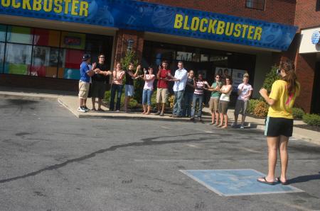 Kirby Maxwell's Focus group stands in front of Blockbuster posing with the take two motion as part of their scavenger hunt through Jackson.