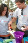 Freshmen Hannah Harvell, an MK from the Phillipines, and Trey Wilcox spread chocolate chips on their ice cream during the annual ice cream social at the home of President Dockery. - Photo by Stephanie Schroeder