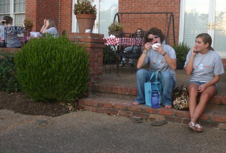 Jana Lawson, a Spanish TESL major from Memphis, enjoys some ice cream in President Dockery's backyard as her friend and fellow freshman Erin Liddle, an art major from Memphis, looks on.
