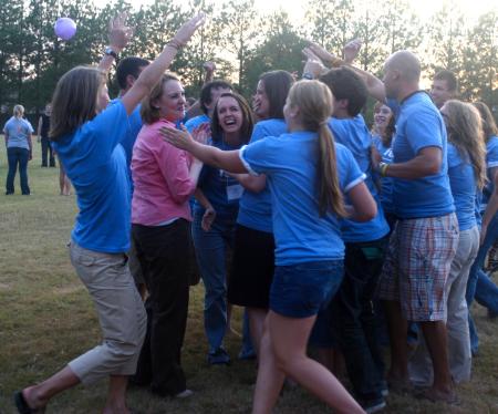 Dean of Students Kimberly Thornbury joins the Focus group leaders in a huddle after having completed some fun while imitating High School Musical at the annual ice cream social held at President Dockery's house.