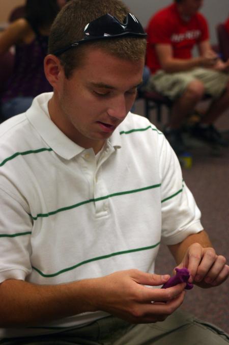 Spencer Plott, a sports medicine major from Paris, TN, displays his Play-Dough figure reflecting a bull that he owns to the rest of his Focus Group. Students were instructed to use the Play-Dough to create a material possession they value.