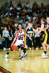 02/46/03 - Sophomore Laura Mitchell (20) drives in for a layup against Blue Mountain.