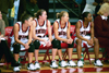 02/46/03 - Freshman Jennifer Henson (11), Freshman Peggy McCain(21), Sophomore Laura Davison (15), and Sophomore Monica Elliot (24) look on from the bench.