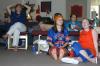 McAfee Resident Director Ashley Jackson, Sophomore Leah Heinsch, and Junior Katrina Parker and cheer on the University of Florida in a game against the University of Tennessee as they watch it projected on a wall in McAfee Commons. - Photo by Stephanie Schroeder