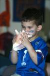 09/15/07 - Matthew Jackson, son of McAfee Residence Director Ashley Jackson, attempts to blow a conk shell during a game projected in McAfee commons.