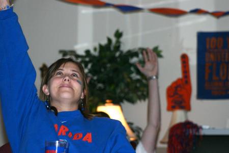 McAfee Residence Director Ashley Jackson cheers on her football team as she and others watch the game projected on a wall in McAfee Commons.