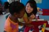 9/27/07 - Sarah Kim explains rockets to a girl at the Boys and Girls Club where Union physics, chemistry and engineering students went to share some principles of science. - Neisha Fuson