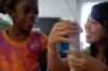 9/27/07 - Sophomore Sarah Kim shows a girl how to make a paper towel roll rocket at a Boys and Girls Club meeting.  - Neisha Fuson