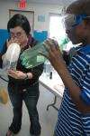 9/27/07 - Michelle Thornhill demonstrates a physics experiment with a boy from a Jackson Boys and Girls Club. - Neisha Fuson