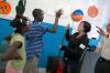 9/27/07 - Michelle Thornhill gives a demonstration at the physics table at a Boys and Girls Club.  - Neisha Fuson