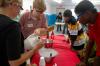 9/27/07 - Children watch as Alicia Bennett and Kent Willis prepare to make ice cream at a Boys and Girls Club. - Neisha Fuson