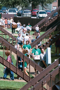 8/24/2002 - Move-in madness: Dozens of students, parents and campus staff were on hand to help more than 400 freshmen move in on Aug. 24. This year's freshman class includes students from 29 states and 11 countries. (ID: 86)