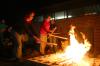 11/29/07 - Sophomores Rebekah Frost and Paige Ward throw more wood into a pit fire.  Ceramics students were firing their projects primitive style. - Stephanie Schroeder