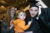 Alex Carr holds his nephew, Camden, as his mom stands behind him at fall graduation. - Photo by Stephanie Schroeder