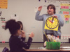 2/20/03 - Assignment: Alison Oshel/Student Teacher - Working on telling time is a large aspect of what Oshel
teaches her first grade class during a math lesson. - Lindsay Stavish