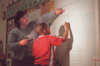 Assignment: Alison Oshel/Student Teacher - During science class, the first graders learned about plants. Tremayne Floyd draws the stem of the plant on the board under Oshel’s direction. - Photo by Lindsay Stavish