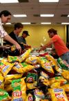 Students and staff get plates of barbeque and a bag of chips during the barbeque lunch provided and prepared by the team members at Gwatney Chevrolet in Memphis, TN.  This generous service was provided in response to the February 5th tornado. - Photo by Kristi McMurry
