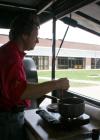 Rick Dalton stirs a special sauce for the bar-b-que that his team at Gwatney Chevrolet is so good at cooking.  Gwatney Chevrolet provided and prepared a delicious barbeque lunch for Union faculty, staff, and students. - Photo by Kristi McMurry