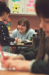 Assignment: Alison Oshel/Student Teacher - Rachel Garrison works diligently on her work while
Savannah Melton reads a book to Oshel. - Photo by Lindsay Stavish
