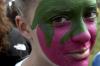 Sarah Patch paints a ZTA strawberry on her face to support her sorority during Greek Olympics. - Photo by Kyle Kurlick