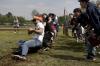 Members of ATO struggle to win the tug-of-war competition at the Greek Olympics while their brothers cheer them. - Photo by Kyle Kurlick