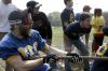 Andrew Corbett shouts to boost his strength as he and members of ATO work to win the tug-of-war competition at the Greek Olympics as fellow fraternity brothers cheer for their team. - Photo by Kyle Kurlick